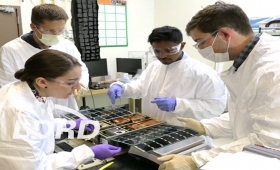 Engineers work on a cubesat