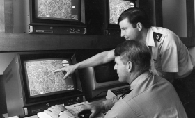 Two men looking at screens