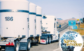 Truck with heavy cylindrical tanks driving toward freeway onramp