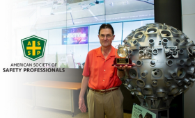 photo of Bruno van Wonterghem standing next to model of NIF target chamber