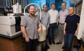 Laboratory employees in front of a gas chromatography mass spectrometer