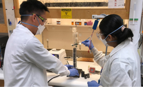 Simon Pang (left) and Buddhinie Jayathilake assemble and prepare a prototype bubble column electrobioreactor to test additively manufactured three-dimensional electrodes. Under their project, excess renewable electricity from wind and solar sources would be stored in chemical bonds as renewable natural gas. 